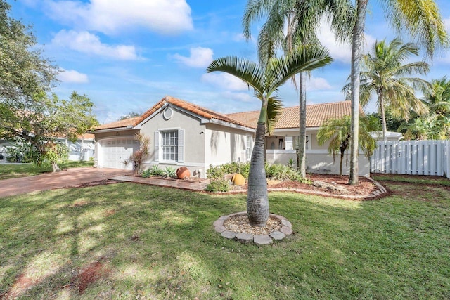 mediterranean / spanish-style home with a garage and a front lawn