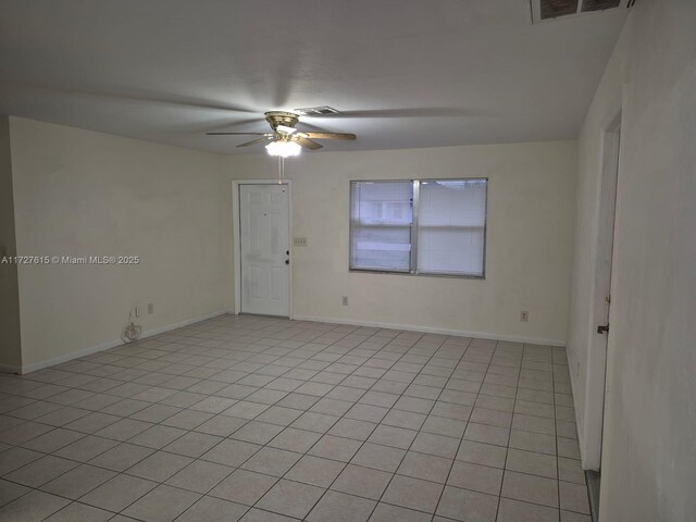 tiled empty room with ceiling fan with notable chandelier and sink