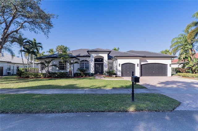 view of front facade with a garage and a front lawn