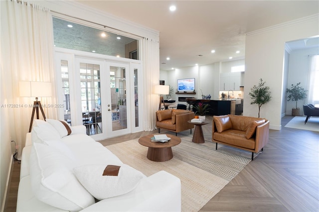 living room with french doors, ornamental molding, light parquet flooring, and sink