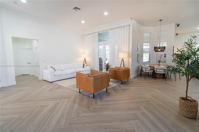 living room featuring ornamental molding and light parquet floors