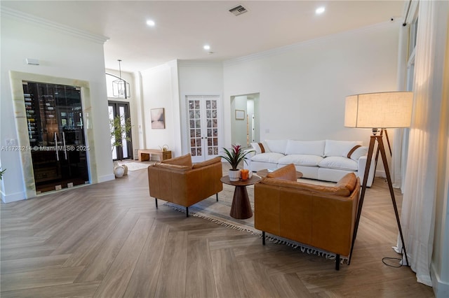 living room featuring light parquet floors, crown molding, and french doors