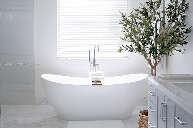 bathroom featuring a tub to relax in and vanity