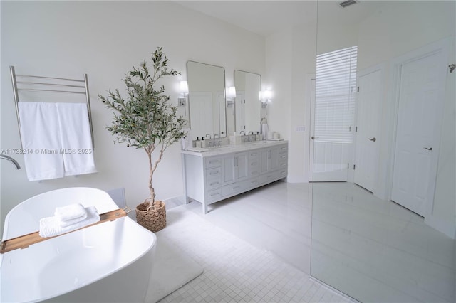 bathroom featuring vanity and a washtub