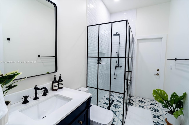 bathroom with vanity, toilet, and a shower with shower door