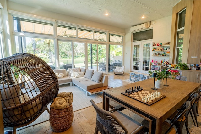 sunroom with a wall mounted AC and french doors