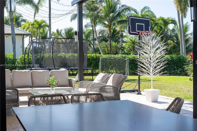 view of patio featuring a trampoline and outdoor lounge area