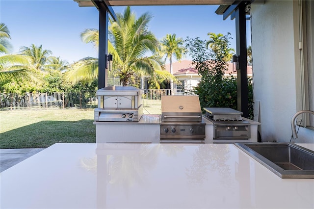 view of patio featuring an outdoor kitchen, sink, and grilling area