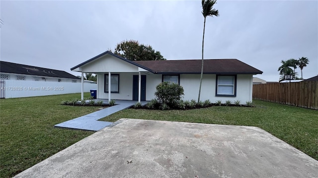 single story home featuring a front lawn