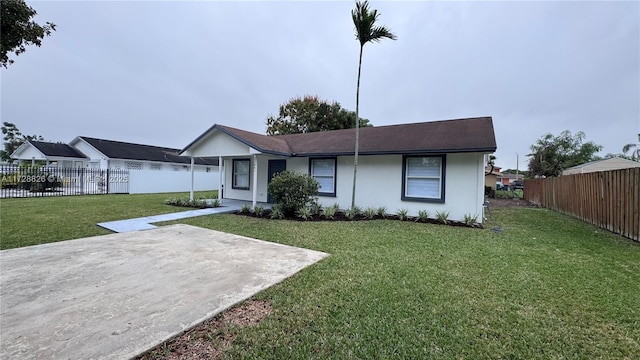 ranch-style house with a patio area and a front lawn