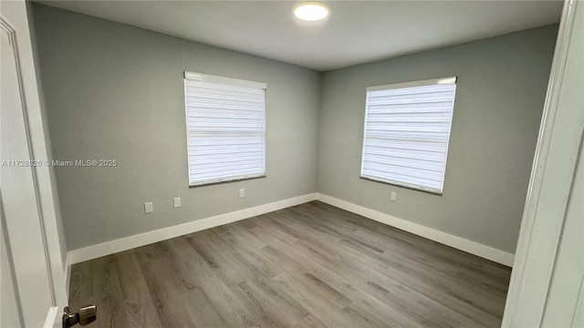 unfurnished room with light wood-type flooring