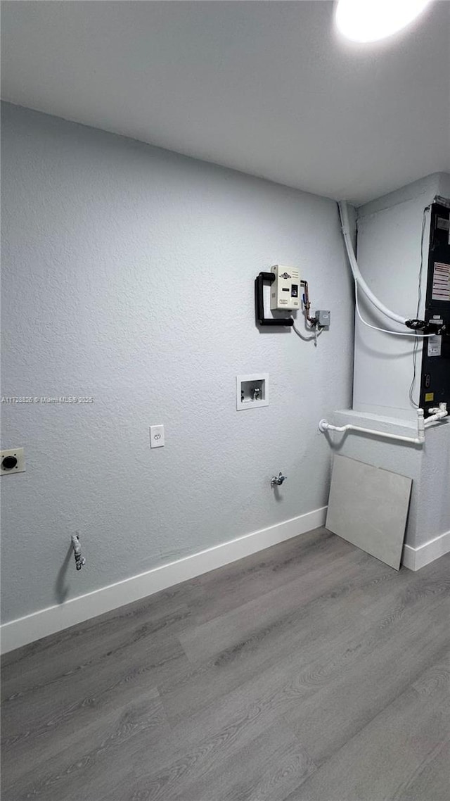 clothes washing area featuring hardwood / wood-style flooring, gas dryer hookup, and hookup for a washing machine