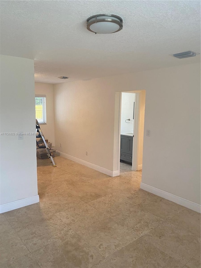 spare room featuring a textured ceiling