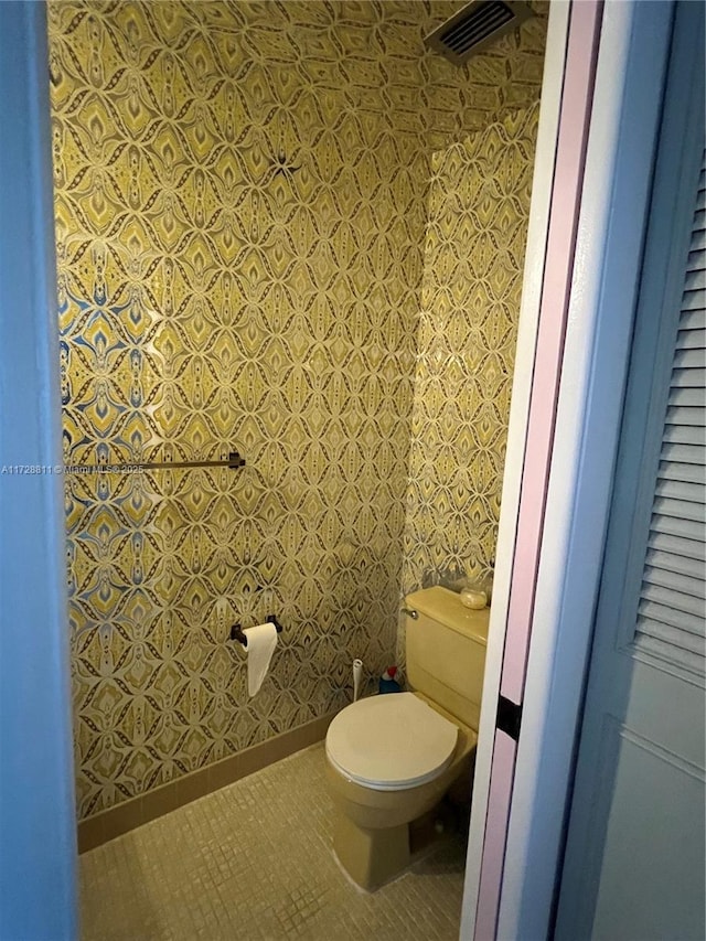 bathroom with toilet and tile patterned flooring