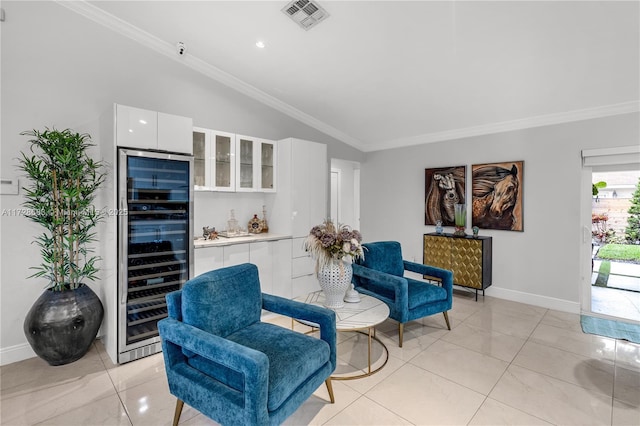 sitting room featuring light tile patterned flooring, vaulted ceiling, ornamental molding, and wine cooler