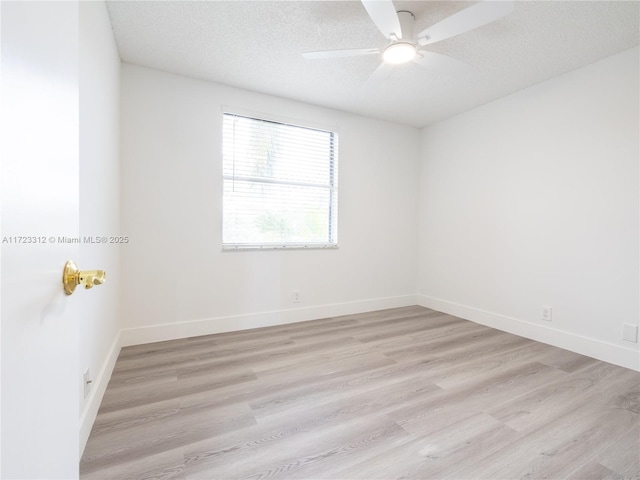 spare room featuring ceiling fan, a textured ceiling, and light hardwood / wood-style flooring