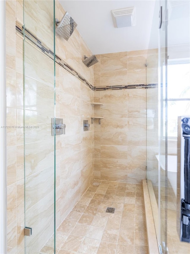 bathroom featuring a shower with door