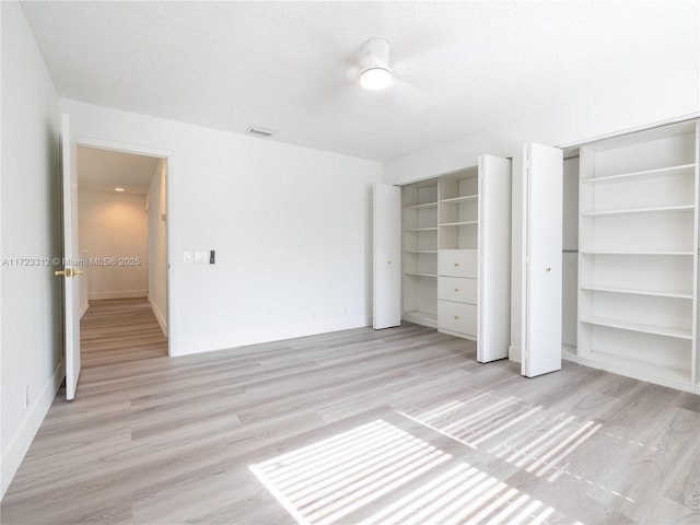 unfurnished bedroom with a textured ceiling, ceiling fan, and light hardwood / wood-style floors