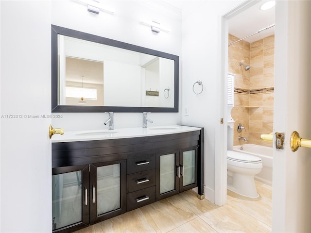 full bathroom featuring toilet, tiled shower / bath, and vanity