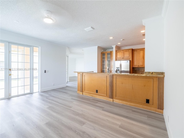 kitchen featuring a textured ceiling, stainless steel fridge with ice dispenser, kitchen peninsula, light hardwood / wood-style flooring, and crown molding