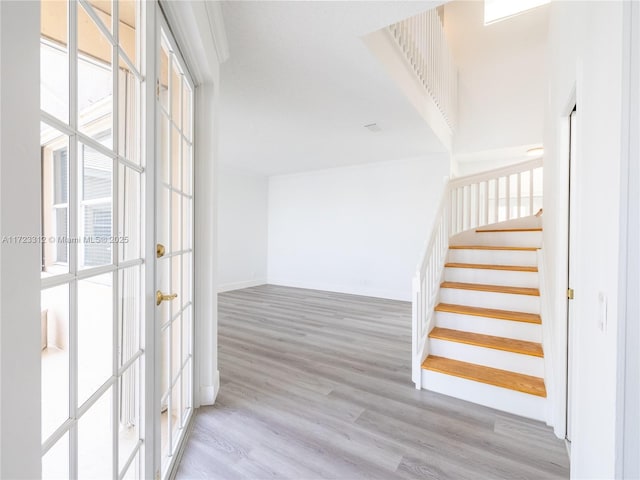 interior space featuring light wood-type flooring and french doors