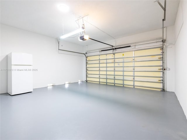 garage with white refrigerator and a garage door opener