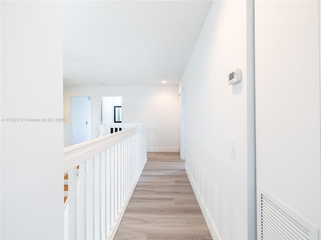 hall with light hardwood / wood-style floors