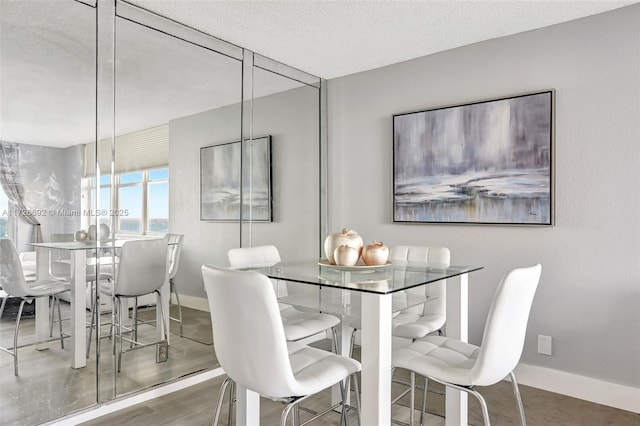 dining space with a textured ceiling