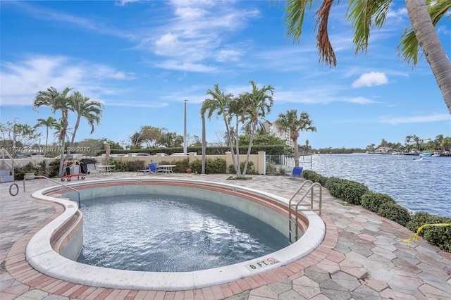 view of swimming pool with a water view