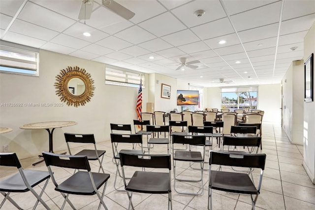 dining space featuring ceiling fan, light tile patterned floors, and a paneled ceiling