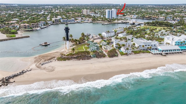 drone / aerial view with a water view and a view of the beach