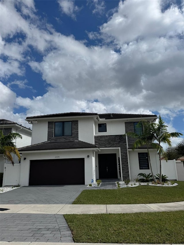 view of front facade with a front lawn and a garage