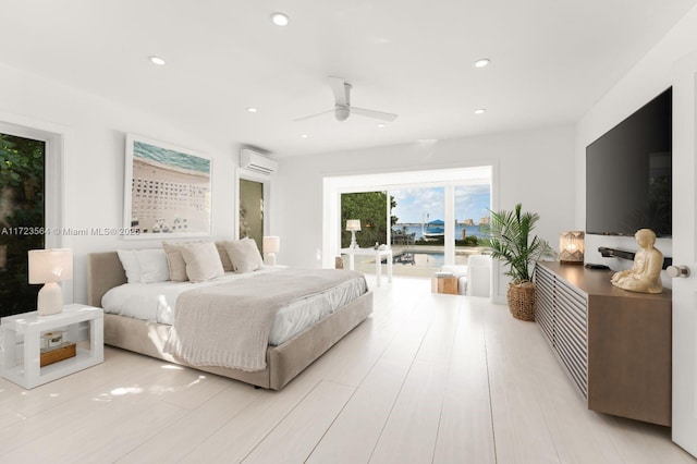 bedroom featuring ceiling fan, a wall unit AC, and access to outside