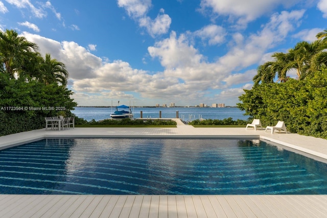 view of pool with a patio area and a water view