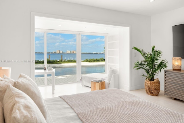 bedroom featuring access to outside and a water view