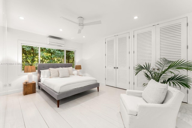 1065 N Shore Dr, Miami Beach, FL 33141 - bedroom featuring a wall unit AC, multiple closets, recessed lighting, a ceiling fan, and baseboards