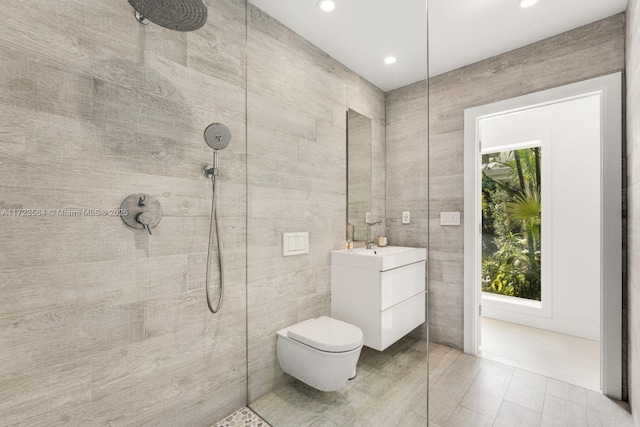1065 N Shore Dr, Miami Beach, FL 33141 - bathroom with recessed lighting, vanity, a tile shower, tile walls, and toilet