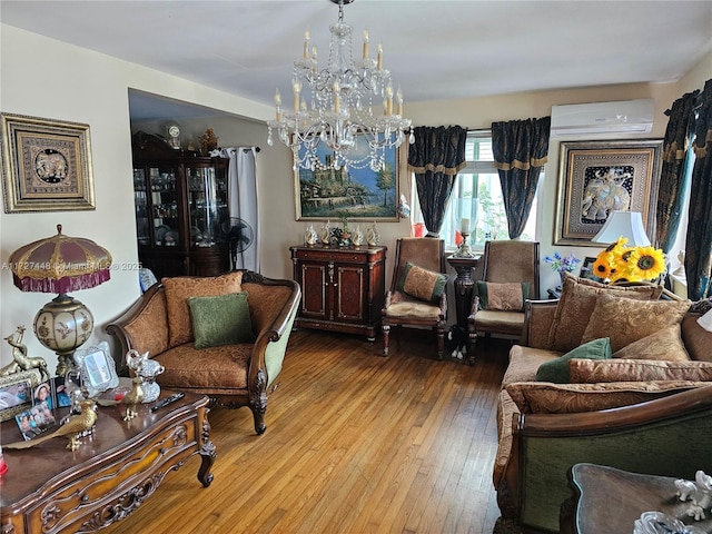 sitting room with a notable chandelier, wood finished floors, and a wall mounted AC