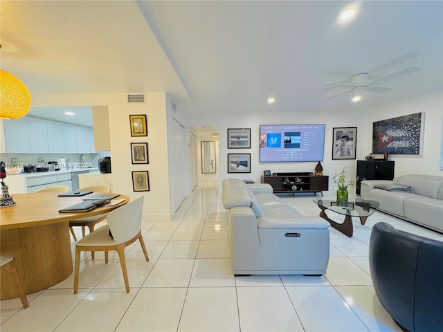 living room with ceiling fan and light tile patterned floors