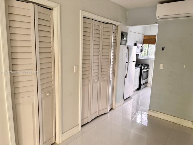 corridor with a wall mounted AC and light tile patterned flooring