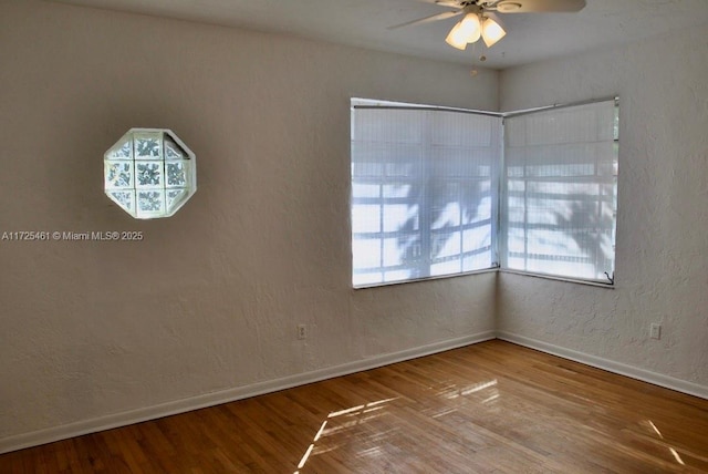 unfurnished room with ceiling fan and hardwood / wood-style floors