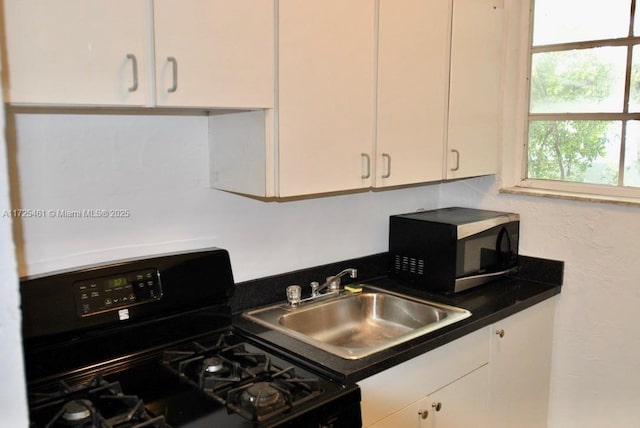 kitchen featuring sink, white cabinets, and black range with gas cooktop