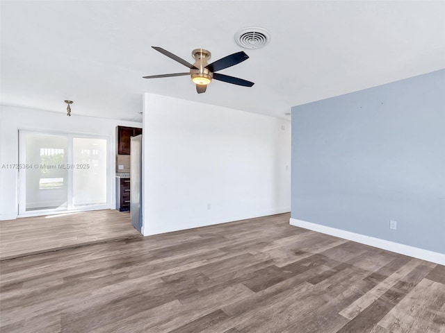 unfurnished room with ceiling fan and hardwood / wood-style floors