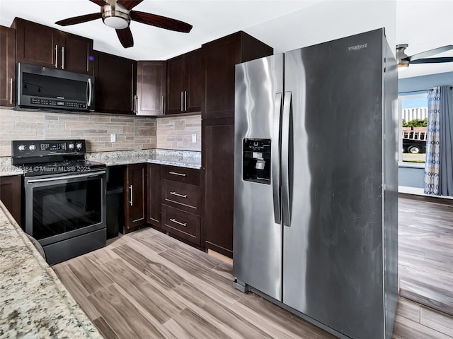 kitchen featuring light hardwood / wood-style floors, stainless steel appliances, tasteful backsplash, dark brown cabinets, and light stone countertops