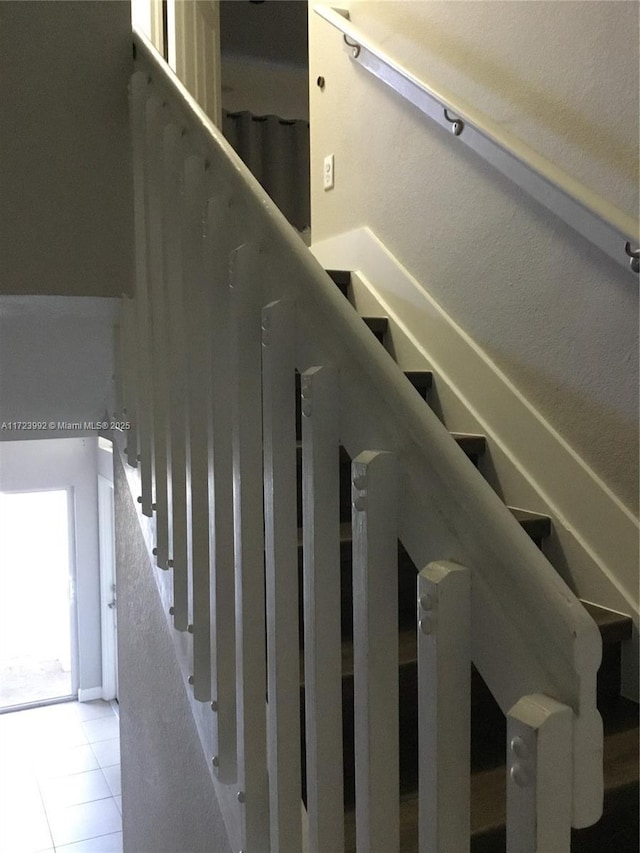 stairs with tile patterned flooring