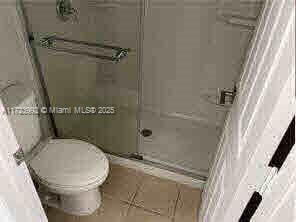 bathroom with toilet and tile patterned flooring