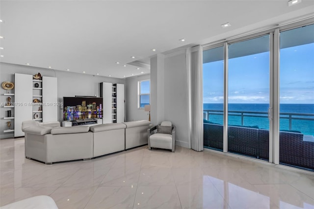 living room with a water view and expansive windows