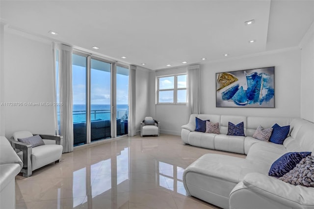 living room featuring a water view, a wall of windows, and crown molding