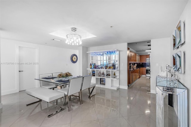 tiled dining room featuring a notable chandelier