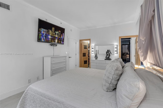 bedroom featuring baseboards, visible vents, and crown molding